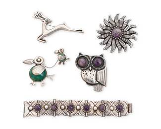 194
A group of Mexican silver and set stone jewelry
Mid-20th century
Each marked: Mexico / Silver
Five works comprising a sterling silver William Spratling-style owl brooch with set amethyst eyes (2.5" H x 2" W), a sterling silver sunflower brooch with central set amethyst (2.625" Dia.), a leaping deer brooch with set turquoise eye (2.25" H x 3" W), and a two-piece pelican motif chatelaine brooch, each bird with set green stone (2" H x 2" W), as well as a sterling silver link bracelet with set amethyst (6.625" L x 1" H)
5 pieces
163.1 grams gross
Estimate: $800 - $1,200