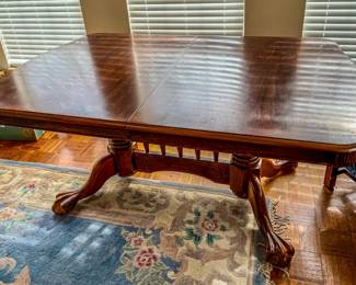Cherry finish dining table with cabriole legs and a removable leaf