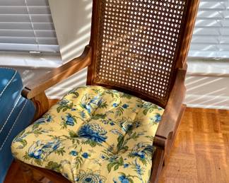 Vintage wooden rocking chair with a caned back