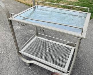 Grey metal bar cart with textured glass top