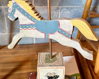 Vintage hand-painted wooden carousel horse figurine on blocks