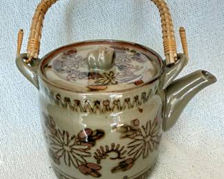 Vintage Stoneware Teapot with a Floral Pattern and Rattan Handle