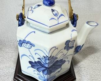 Vintage Asian Inspired Blue and White Porcelain Hexagonal Teapot with a Brass Handle on a Wooden Base