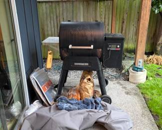 Traeger grill with accessories as found for sale during in person shopping.  Needs some cleaning.  Two covers included.