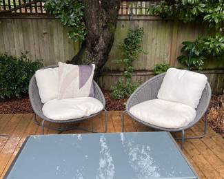 $550    A pair of Crate and Barrel Moroccan Graphite outdoor chairs close up 