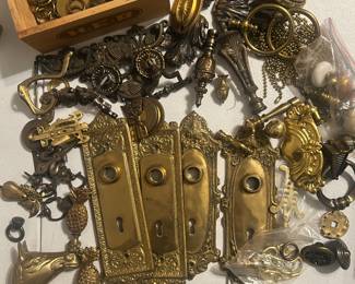 Some brass knob plates, wall hooks, drawer pulls, lamp finials, curtain stays, and more