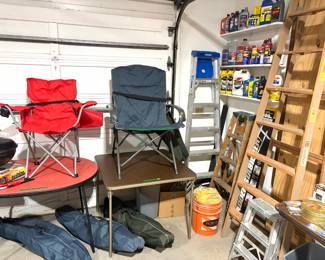 Two folding director-style chairs, ladders, small barbecue grill and outdoor tables. 