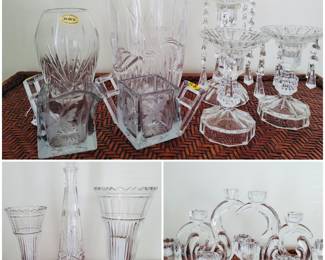 A collection of crystal and glass vases, candle holders and candelabras. 