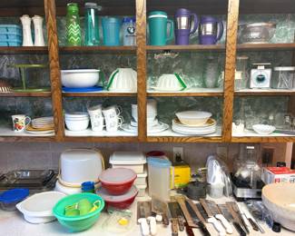 A collection of vintage and modern kitchenware and food storage items. 
