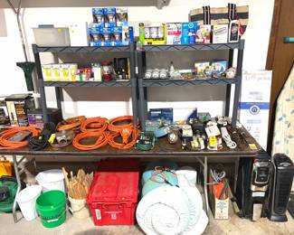 An assortment of extension cords, light bulbs, and electric space heaters.