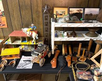 A vintage Marx Bar-M-Ranch tin litho playset, a collection of vintage wooden textile spools and bobbina, wall art and a braided leather bullwhip