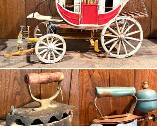 A vintage metal stagecoach display model, and two types of antique clothes irons. 