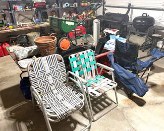 Vintage aluminum-frame webbed folding lawn chairs and a Scotts Turf Builder EdgeGuard Mini Broadcast Spreader. 