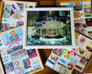 A framed Nebraska Cornhuskers Memorial Stadium wall art print and a collection of framed keepsake Husker ticket memorabilia.