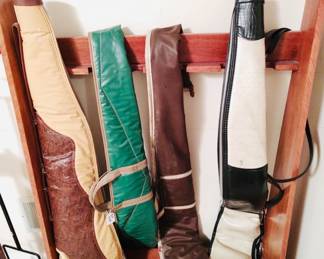 Wooden gun rack, and several vintage soft-sided gun cases. 
