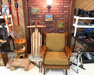 A vintage mid-century modern platform spring rocking chair, a vintage Flexible Flyer wooden snow sled, and a vintage handmade wooden wagon.
