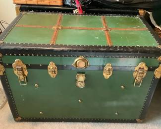 Vintage green metal steamer trunk with black banding and brass fittings 