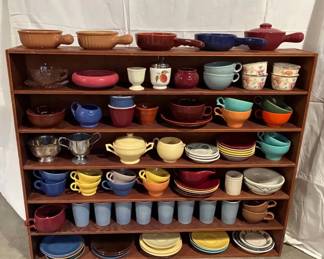A Shelf Full Of Colorful Pottery