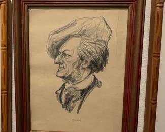 A framed print of a charcoal portrait of Richard Wagner.