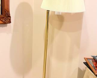 Swinging floor lamp with a brushed antique brass finish