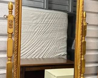 Gold Colored Mirror on Wooden Stand