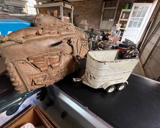 Collectible wooden and metal kids' toys and sports supplies. Leather baseball gloves, baseball bats, etc.