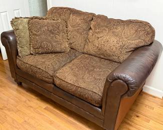 Small couch or loveseat - mixed leather and cloth material. Two pillows included.