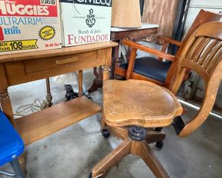 Antique, rustic desk with drawer and matching rolling chair.