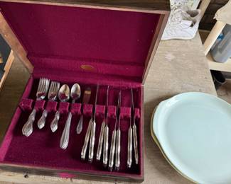 Antique silverware and collectible plates.