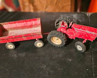 Vintage Ertl pressed steel red tractor and trailer toy set.