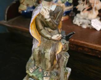 Staffordshire pearlware figure of a seated man with a bird, attributed to Walton.