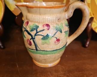 Vintage ceramic pitcher with hand-painted cherry branch decoration.