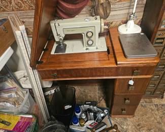 Vintage Sears Kenmore sewing machine with wooden desk cabinet and buttonholer.