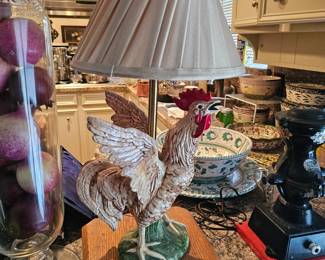 A vintage ceramic rooster lamp base with a pleated lampshade.