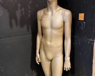 Full-size vintage store mannequin with smooth, minimalist form and neutral beige finish. Features articulated arms and a sleek, modern silhouette. Ideal for retail display, studio use, or visual merchandising. Shows light surface wear consistent with age and use.