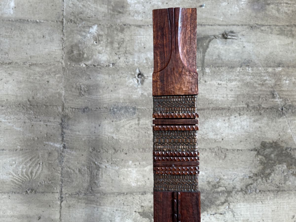 This lot features an incredible mahogany and copper sculpture by listed Oregon artist, Monica Setziol-Phillips. This piece sits in a custom iron base and measures, 75” H x 18” W x 13” D. Monica Setziol-Phillips has a B.A. degree in foreign languages from Portland State University. Monica who is married to Oregon Shakespeare Festival actor, Josiah Phillips, and daughter of well rememberd sculptor, Le Roy Setziol has been weaving for over 35 years and carving for over 20 years. Her work is in many private collections in many states. She also has work in puplic spaces, most recently three of her pieces were chosen for The Allison, the new resort in Newberg. In October of 2009 Monica finished a major work for the new Civic Hall in McMinnville, Oregon. For a number of years she has participated in the Sitka Art Invitational.

