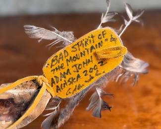 "Bad Spirit of the Mountain", an original carving by listed Alaskan artist, Adam John. Signed and titled on the verso circa 2002 and measures, 12” H x 5” W. Adam John is a noted Athabascan Native artist from Alaska, known for his traditional carvings, especially spirit masks and small sculptures, often depicting animals like owls or mountain spirits, and signed pieces can be found on art sites and auction platforms like eBay, continuing a heritage of Alaskan Native art. He’s associated with Central Alaska and his work is recognized for its cultural significance and craftsmanship. 

