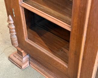 This lot features an early antique cherry wood display cabinet or bookcase. Two pieces (base is separate) with locking doors and skeleton key included. One glass pane is missing and some trim could be reattached that is included. This piece measures, 56.25” H x 42” W x 16.5” D.

