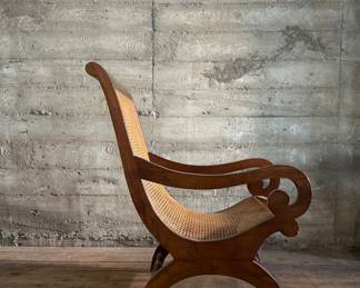 This lot features a British Colonial style plantation lounge chair with a matching ottoman in very good overall condition. The chair measures, 41” H x 24.5” W x 33” W.

