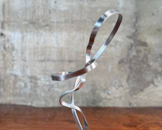 “Mother and Child”, a steel sculpture by listed artist, Fred Doolin. Signed underneath as shown in photos and measures, 13” H x 6” W x 6” D.

