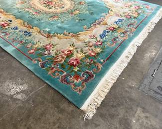This lot features a hand-knotted Chinese Aubusson wool rug featuring a floral medallion design that measures, 144” H x 107” W.

