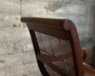 This lot features a British Colonial style plantation lounge chair with a matching ottoman in very good overall condition. The chair measures, 41” H x 24.5” W x 33” W.

