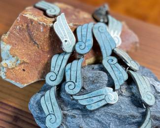 This lot features a gorgeous set of Taxco jewelry with sterling silver and inlaid blue stone with a marble-like appearance. The necklace measures, 17” and the bracelet, 7”. All items bear a maker’s mark as shown in photos with a total approx. weight of 58.00 grams.

