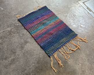 This lot features a beautiful handwoven, multi-color rug or wall art that measures, 35” H x 24.5” W.

