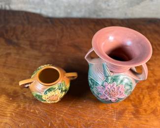 This lot features a pair of antique Roseville Pottery Vases. Two minor chips shown in photos and larger vase measures, 9.25” H x 8” W x 7” D.

