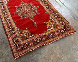 This lot features an antique handwoven Persian rug that measures, 74” H x 49” W.


