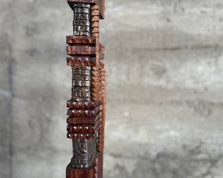 This lot features an incredible mahogany and copper sculpture by listed Oregon artist, Monica Setziol-Phillips. This piece sits in a custom iron base and measures, 75” H x 18” W x 13” D. Monica Setziol-Phillips has a B.A. degree in foreign languages from Portland State University. Monica who is married to Oregon Shakespeare Festival actor, Josiah Phillips, and daughter of well rememberd sculptor, Le Roy Setziol has been weaving for over 35 years and carving for over 20 years. Her work is in many private collections in many states. She also has work in puplic spaces, most recently three of her pieces were chosen for The Allison, the new resort in Newberg. In October of 2009 Monica finished a major work for the new Civic Hall in McMinnville, Oregon. For a number of years she has participated in the Sitka Art Invitational.

