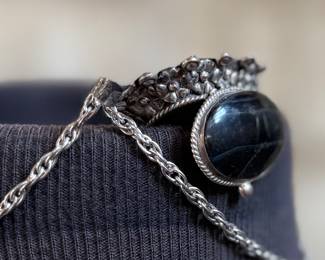 This lot features a "poison locket" pendant on a sterling silver chain measuring 18” with a total approx. weight of 34.31 grams.

