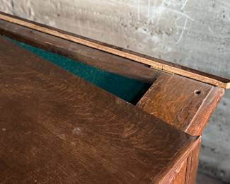 This lot features a vintage solid wood apothecary style or print maker’s cabinet. Comes on casters with multiple sized pull out drawers. The top "lift up" board is currently not attached to the backside trim, but can be easily fixed or left as is. The top cabinet area has green felt. This cabinet measures, 33.25” H x 46” W x 23” D.

