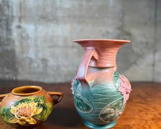 This lot features a pair of antique Roseville Pottery Vases. Two minor chips shown in photos and larger vase measures, 9.25” H x 8” W x 7” D.

